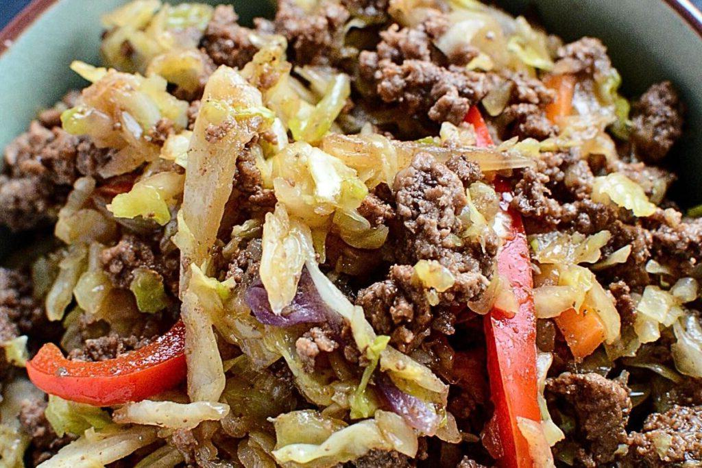 Ένα μπολ με stir fry λάχανο και μοσχάρι.
