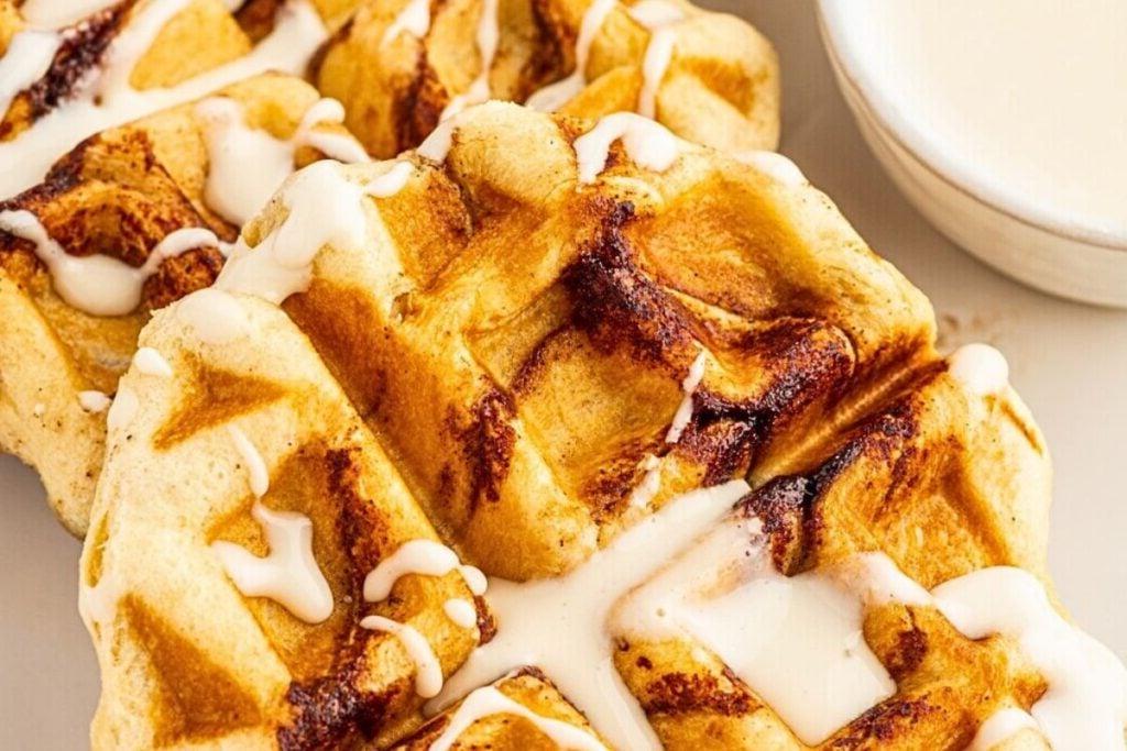A plate of cinnamon rolls cooked in a waffle iron.