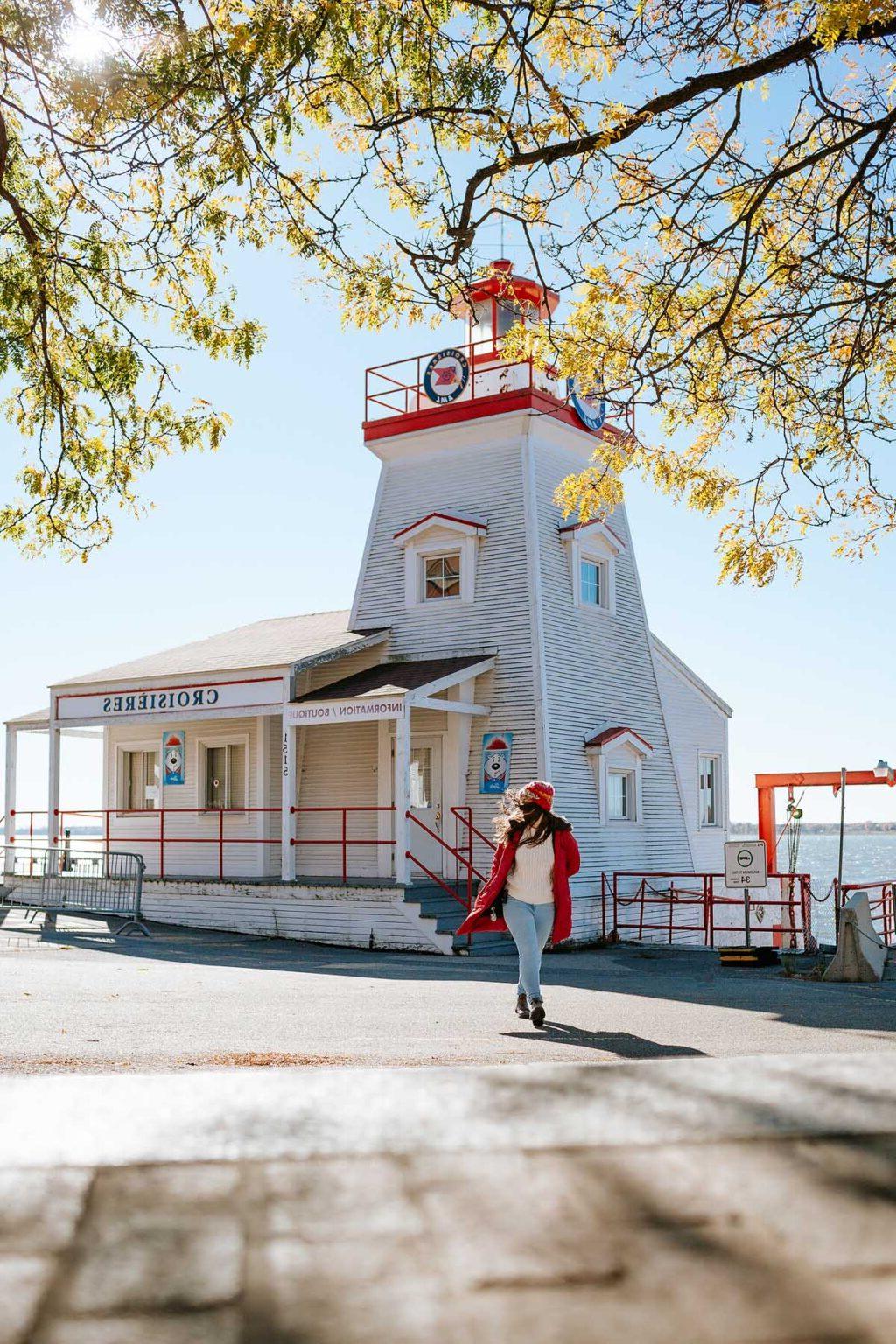 Woman by a lighthouse in Quebec.