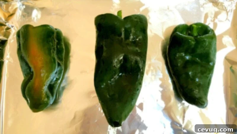 Πιπερότυρο Ντιπ 5 poblano pepper on a baking sheet with tin foil for roasting