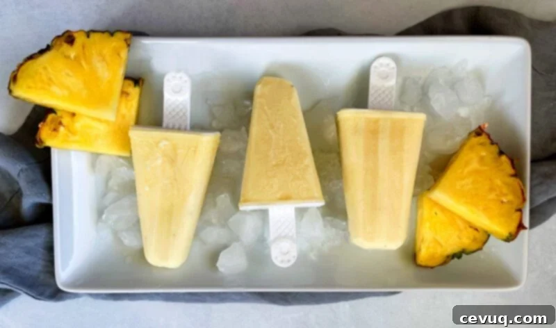 Δροσερό Ξυλάκι Ανανά 2 pineapple popsicles on a tray of ice
