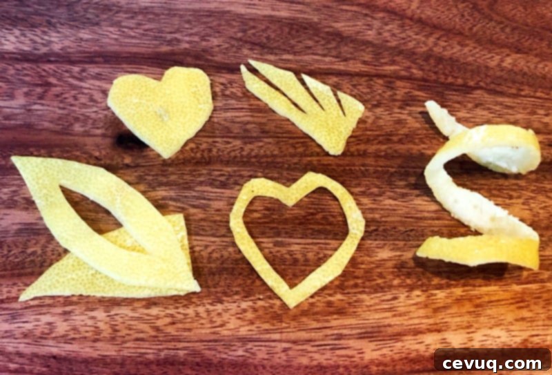 Κοκτέιλ Τζιν με Άνθη Κουφοξυλιάς 5 lemon peel garnishes on a wooden cutting board