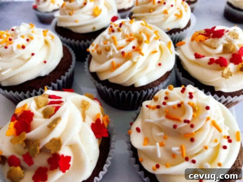 Κρέμα Καραμέλας Μήλου 2 pumpkin molasses cupcakes with caramel apple frosting and sprinkles.