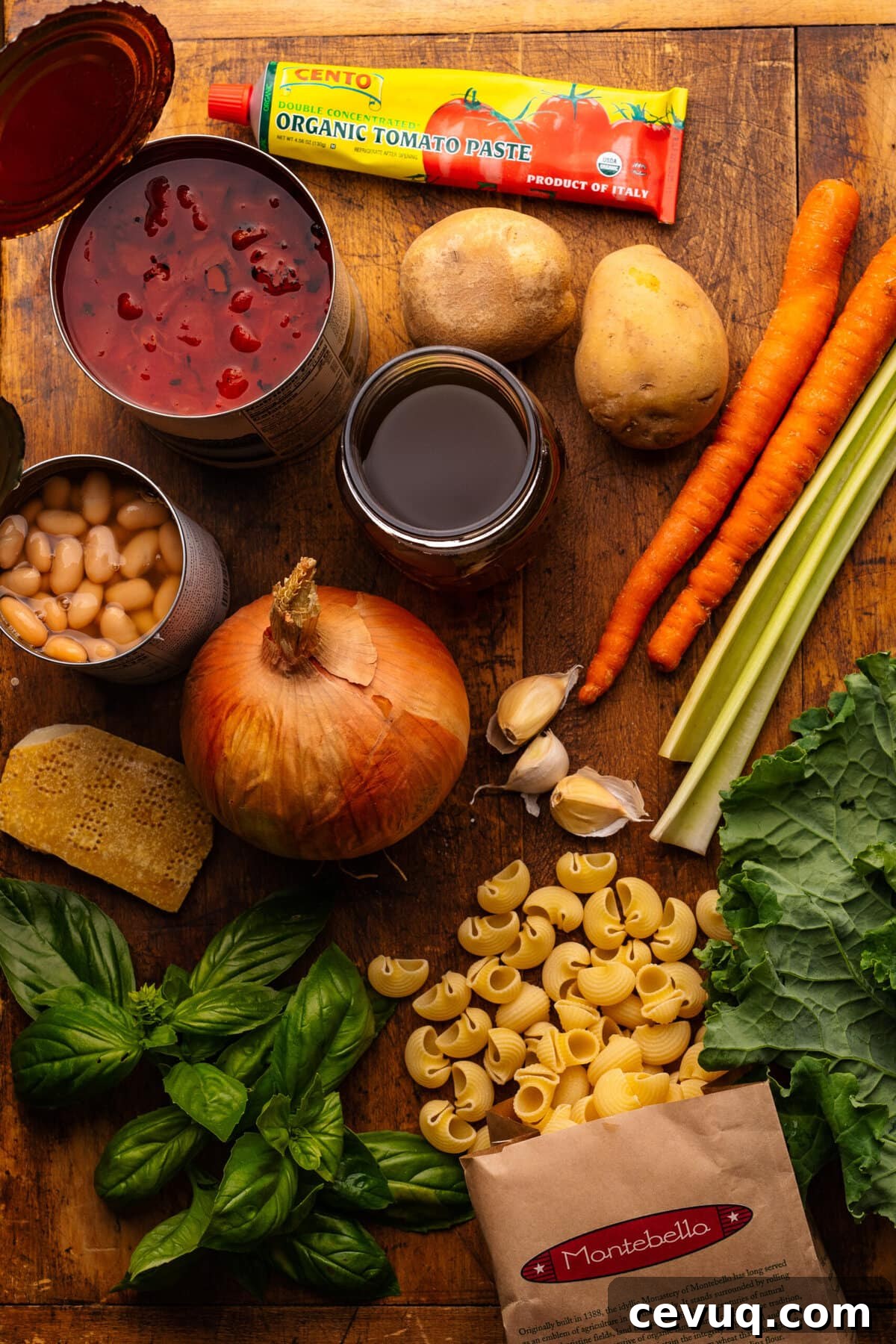 Ingredients for minestrone soup displayed on a wooden background.
