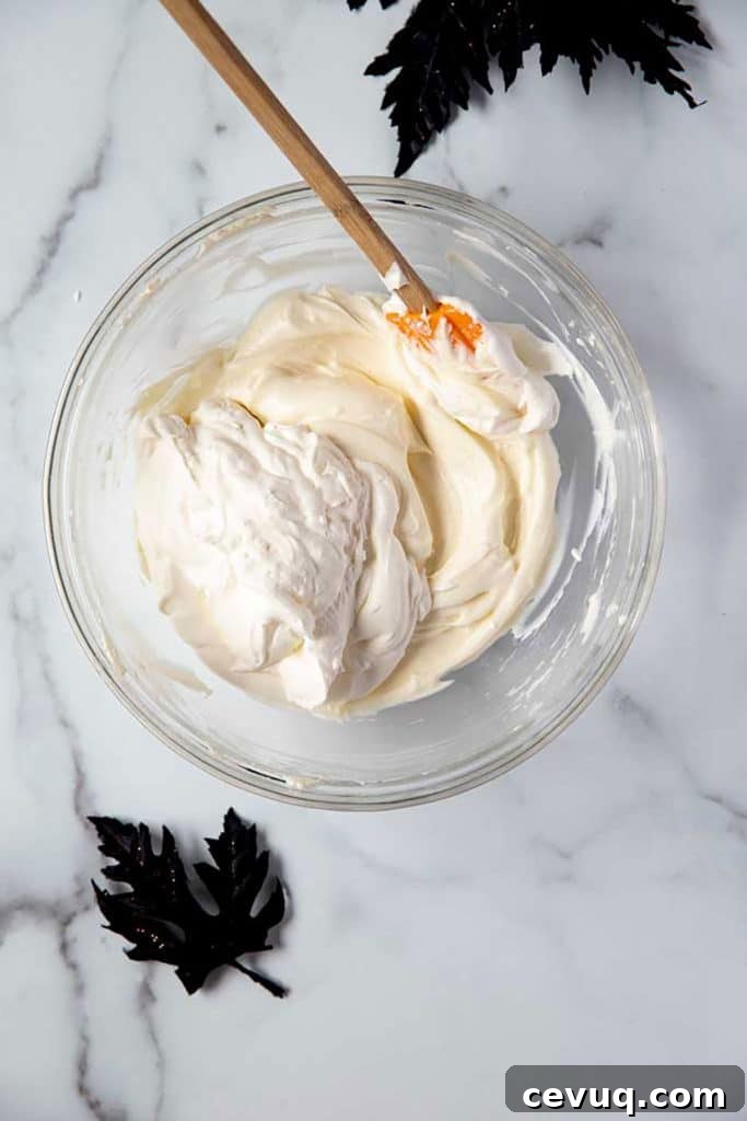 Folding the whipped cream into the cream cheese mixture