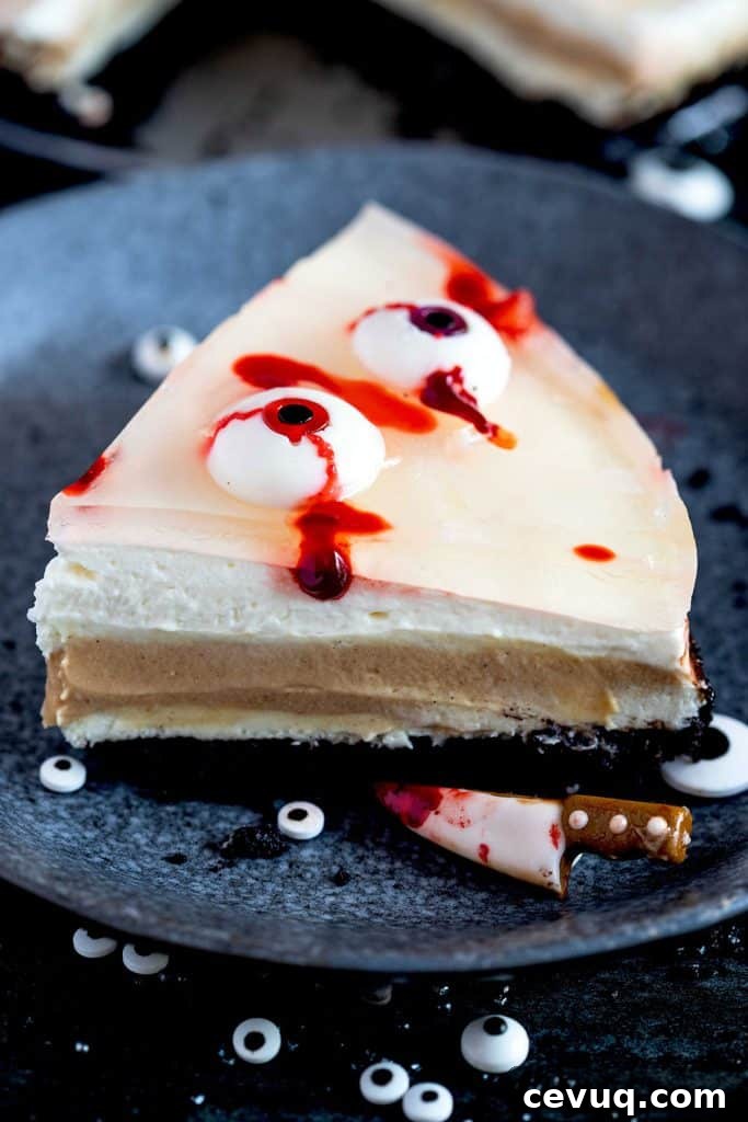 Slice of halloween cheesecake with gummy eyeballs.
