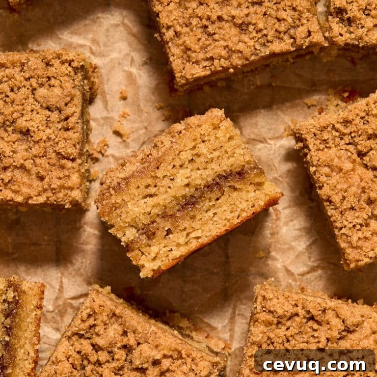 Pieces of almond flour coffee cake arranged on crumpled brown parchment paper.
