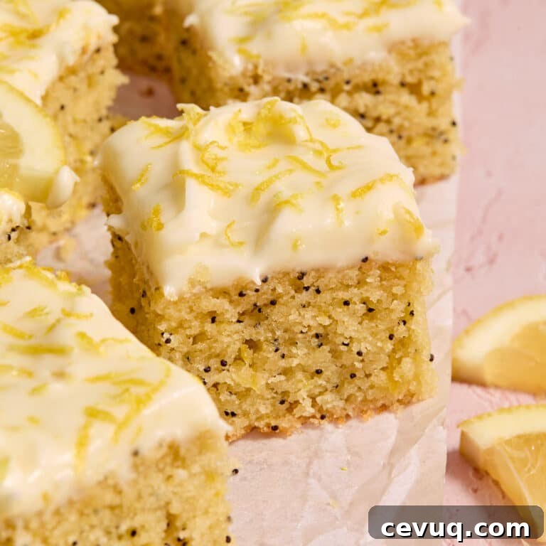 Pieces of almond flour lemon poppy seed cake arranged on parchment paper.
