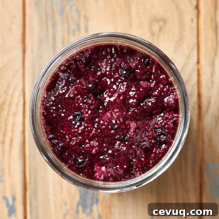 Overhead view of triple berry chia seed jam in a glass jar.