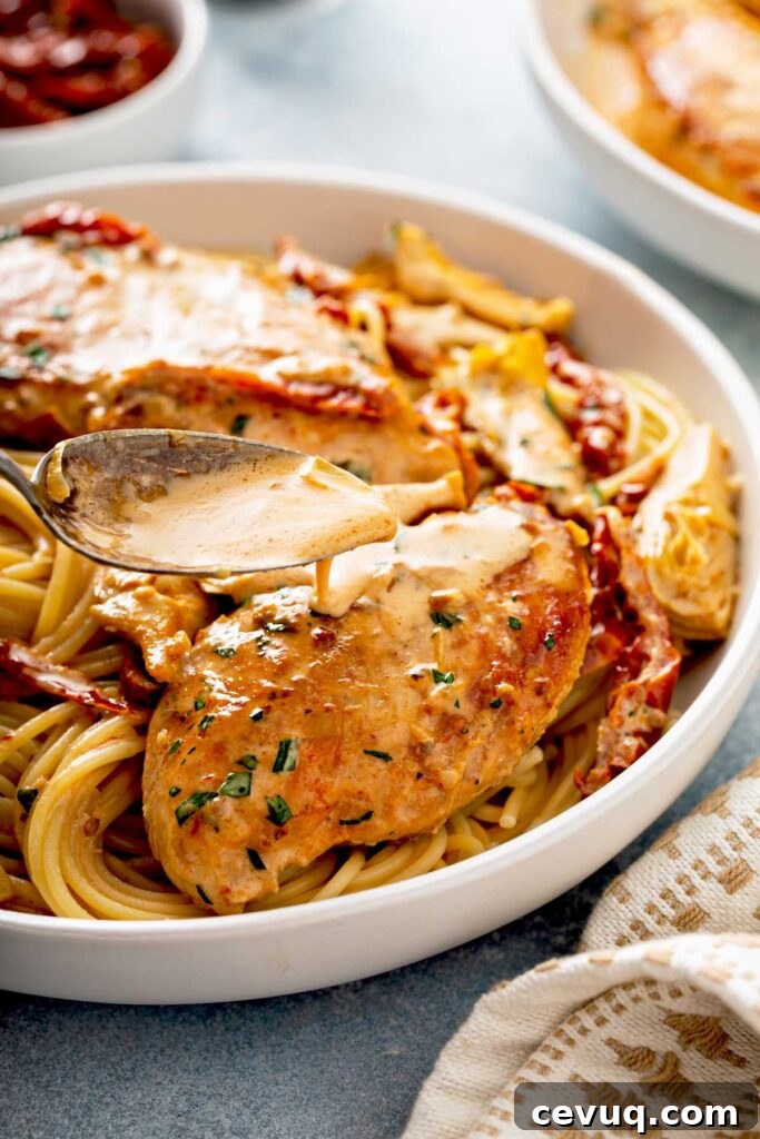 Creamy Sun-Dried Tomato Chicken with Garlic and Herbs 3 Creamy sun dried tomato sauce is poured over juicy golden brown chicken breast on a bed of pasta.