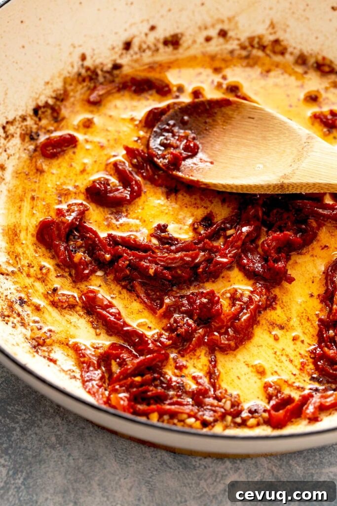 Creamy Sun-Dried Tomato Chicken with Garlic and Herbs 6 Minced garlic and sun dried tomato strips getting sautéed in a skillet.