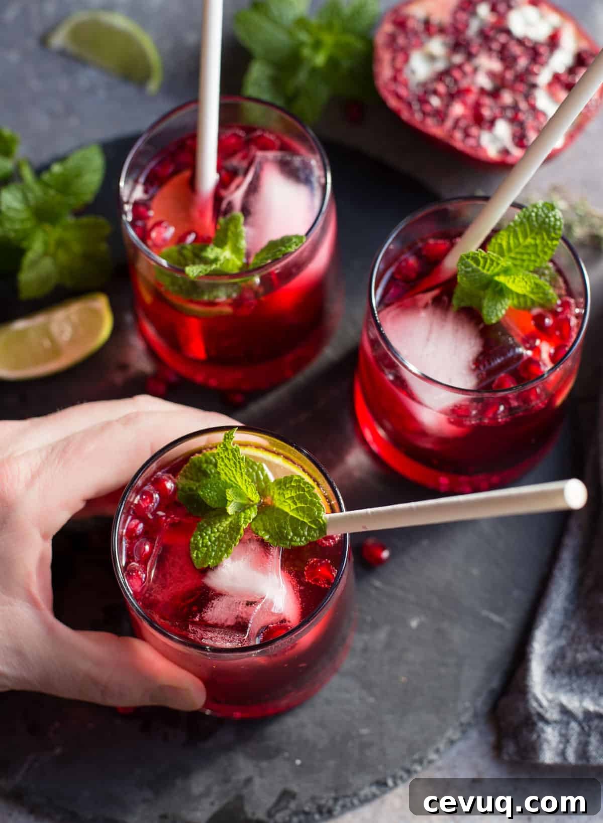 Three glasses filled with ginger pomegranate cocktails