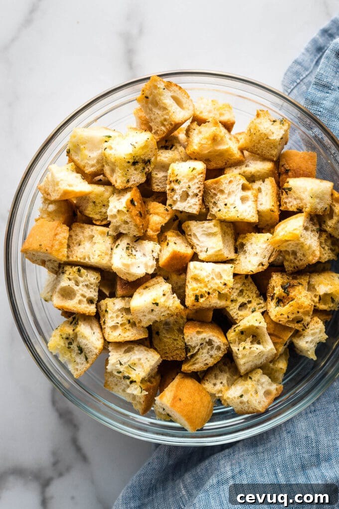 Crunchy homemade croutons in a clear bowl.