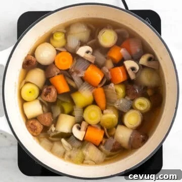 Homemade vegetable broth cooking in a pot