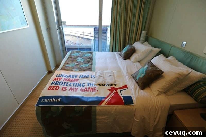 Carnival Sunshine Cloud 9 Spa Stateroom Tour & Review (Video) 5 stateroom bed with luggage mat looking out window to balcony