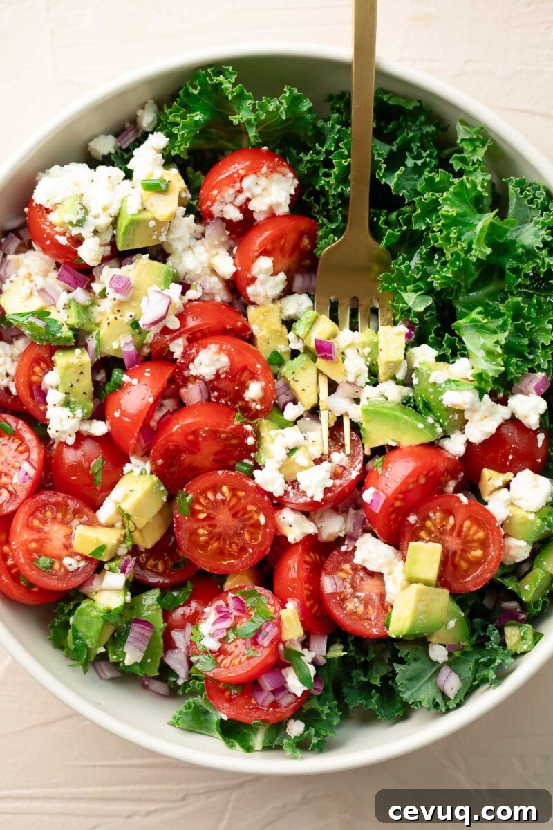 Kale Salad with avocado, red onion, tomatoes, and feta