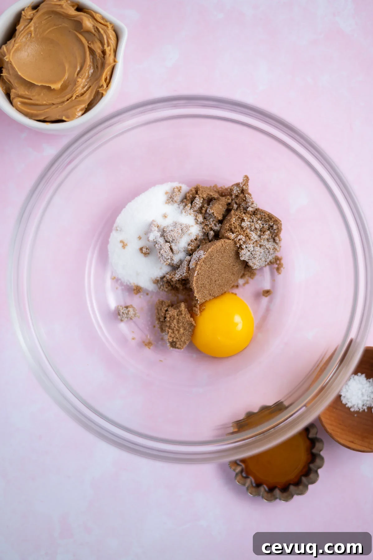 egg yolk, brown and granulated sugar in a bowl