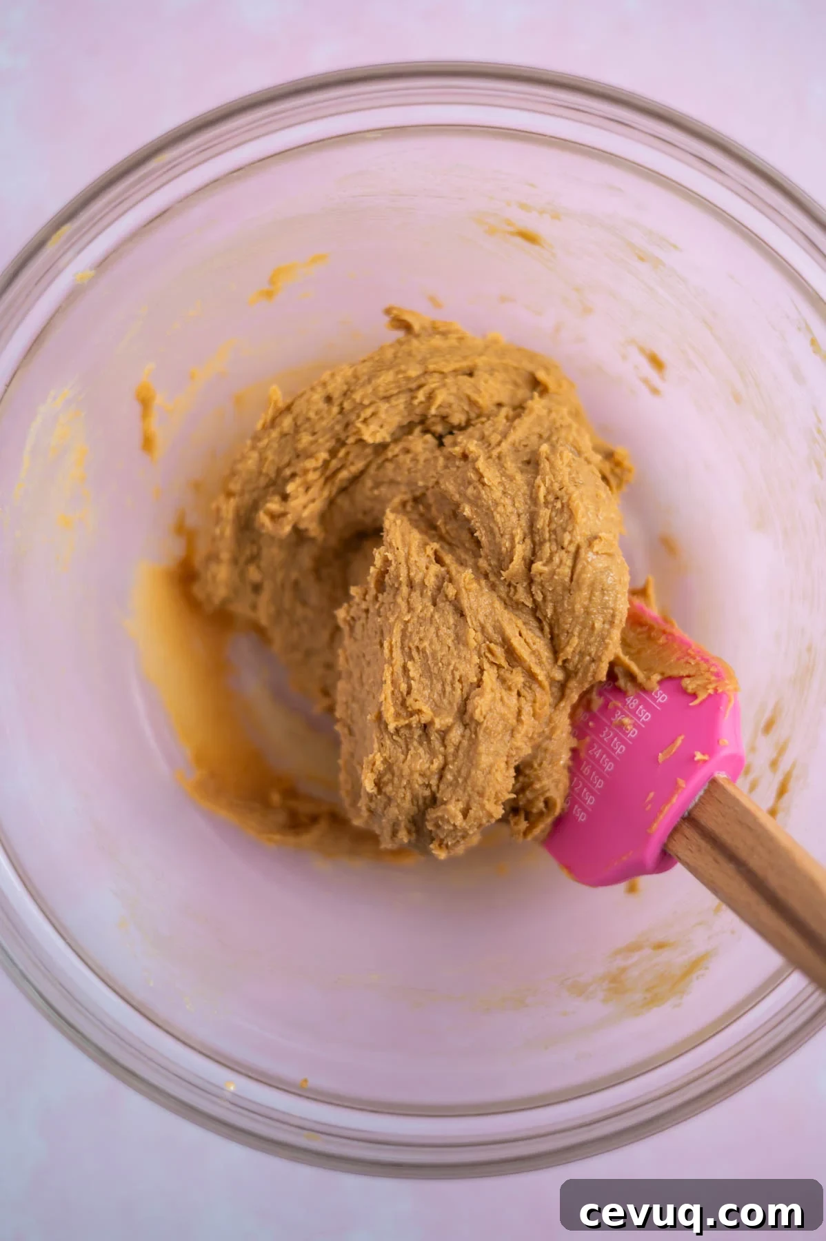 peanut butter cookie dough mixed in a bowl with a spatula