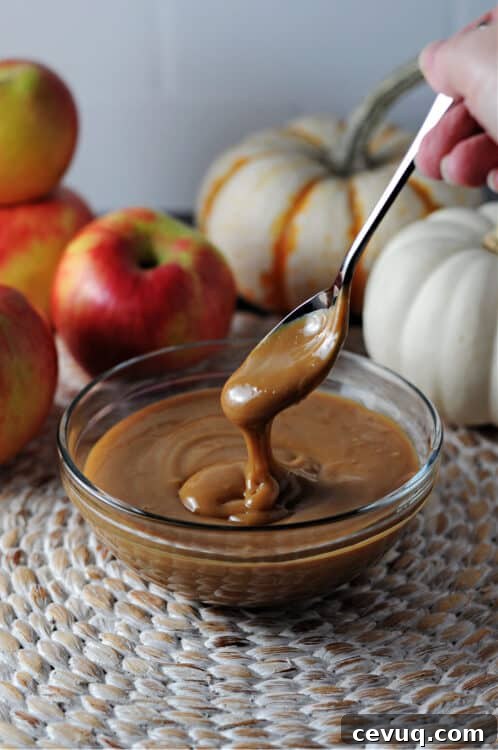 Instant pot caramel sauce spooned from a bowl