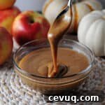 instant pot caramel sauce dripping from a spoon into a bowl