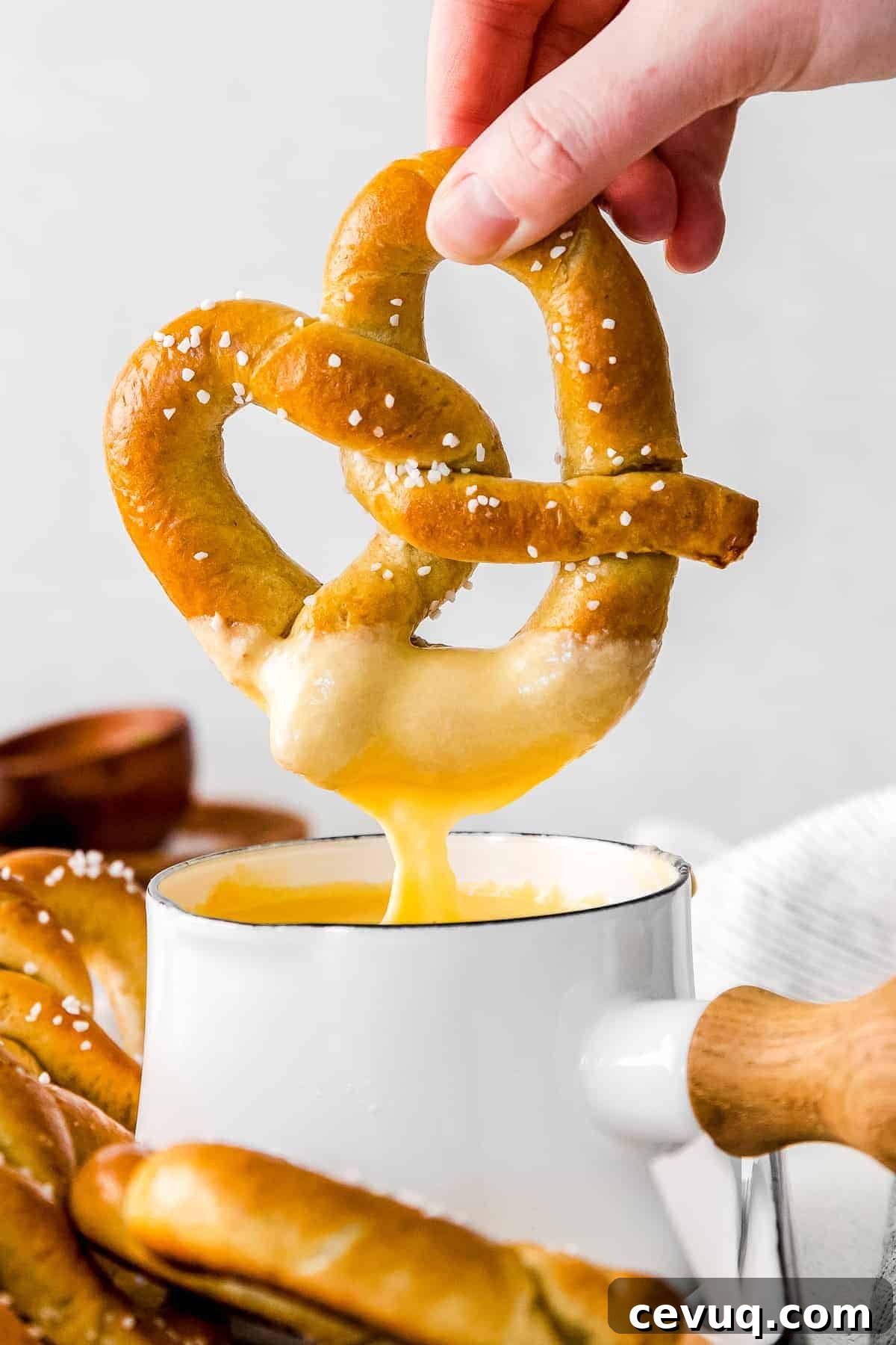 Dipping a pretzel into beer cheese dip.