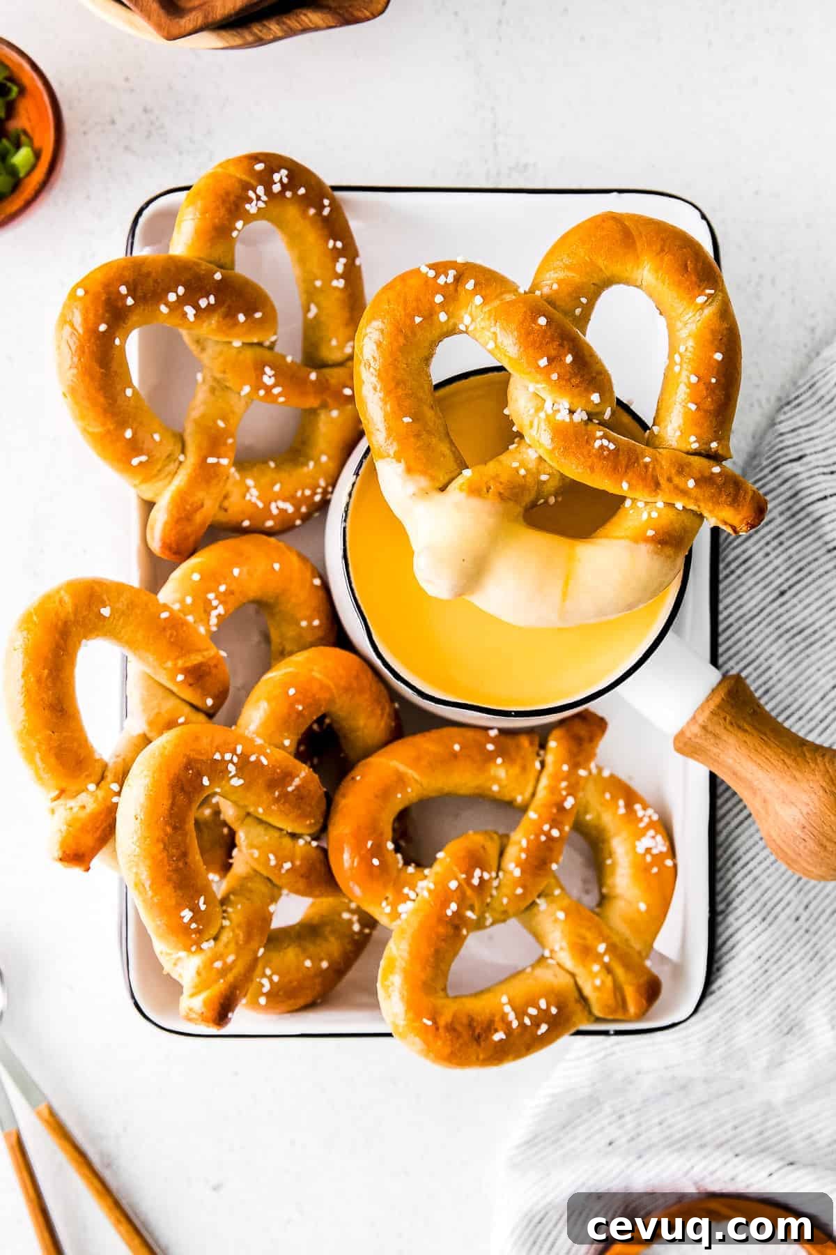 A soft pretzel dipped in beer cheese dip.