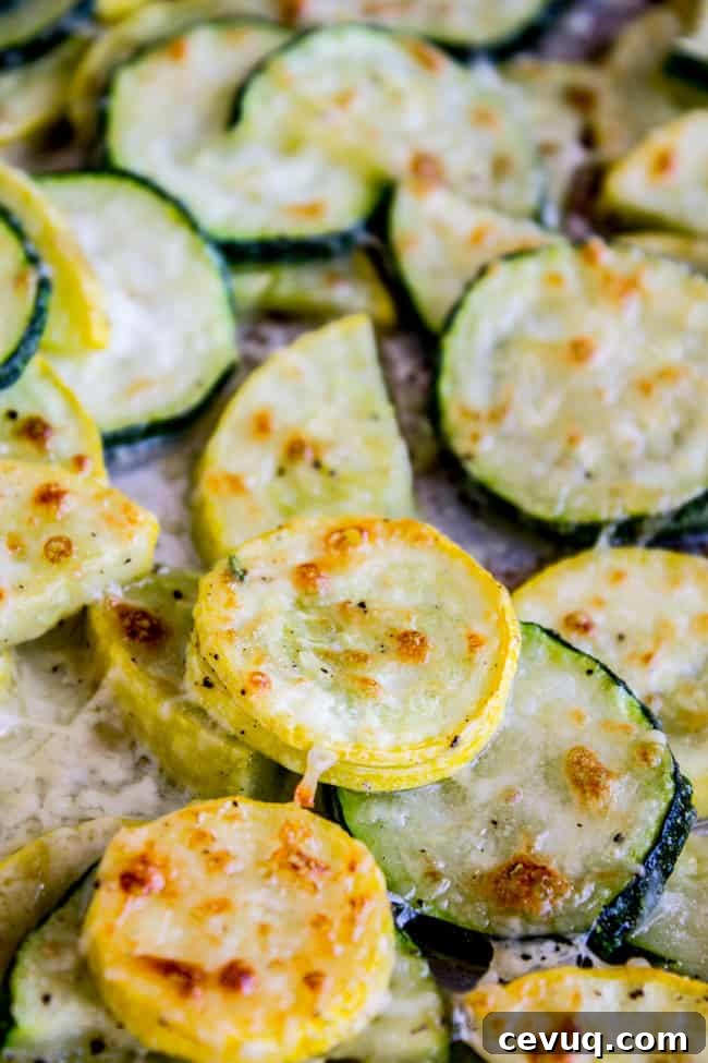 Parmesan Baked Zucchini and Summer Squash Roast 3 Baked parmesan zucchini and yellow squash on a pan.