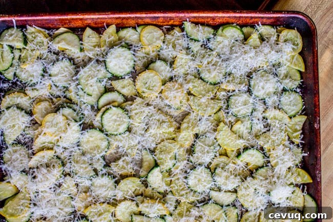 Parmesan Baked Zucchini and Summer Squash Roast 4 Parmesan, zucchini, and squash on a pan.
