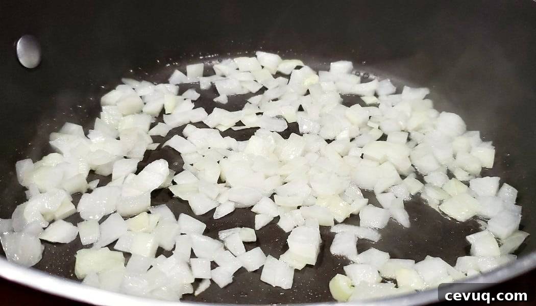 diced onions cooking in a frying pan