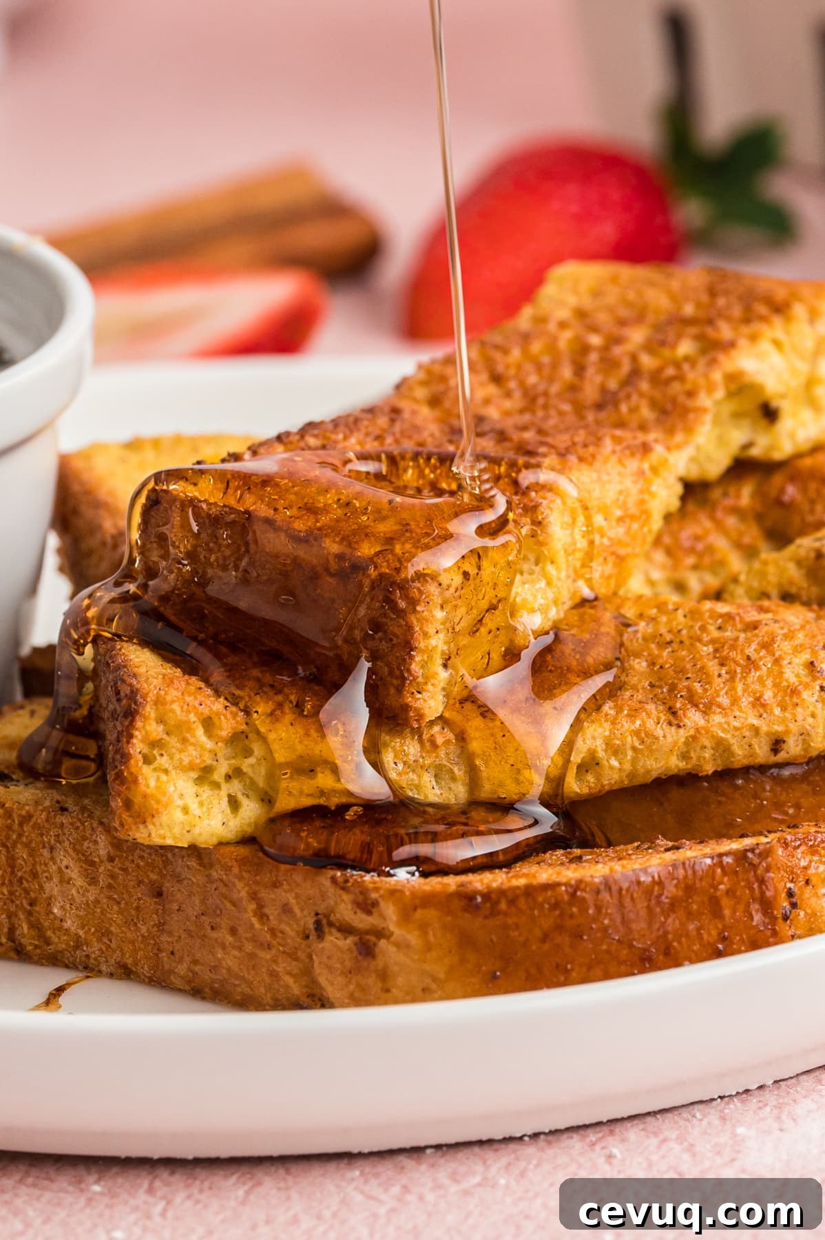 Air fryer French toast sticks topped with syrup
