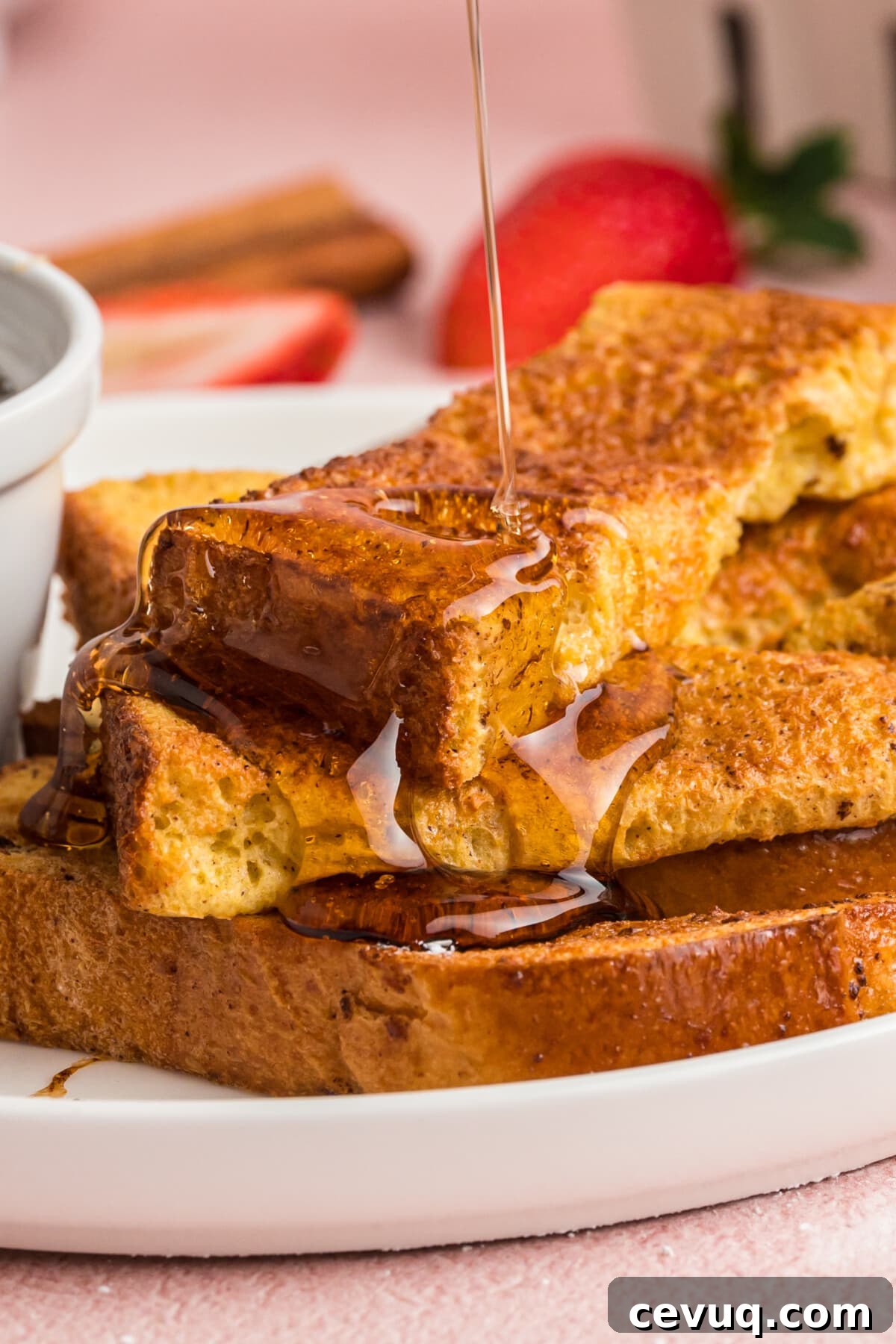 Air Fryer French Toast Sticks stacked on a plate