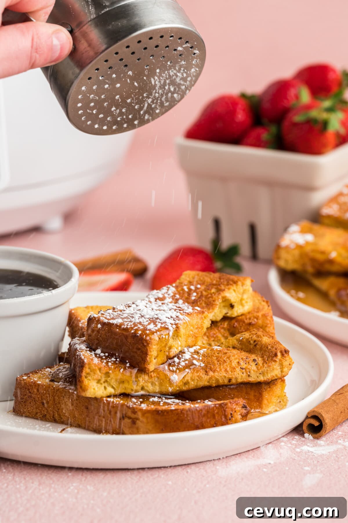 dusting powdered sugar over french toast sticks