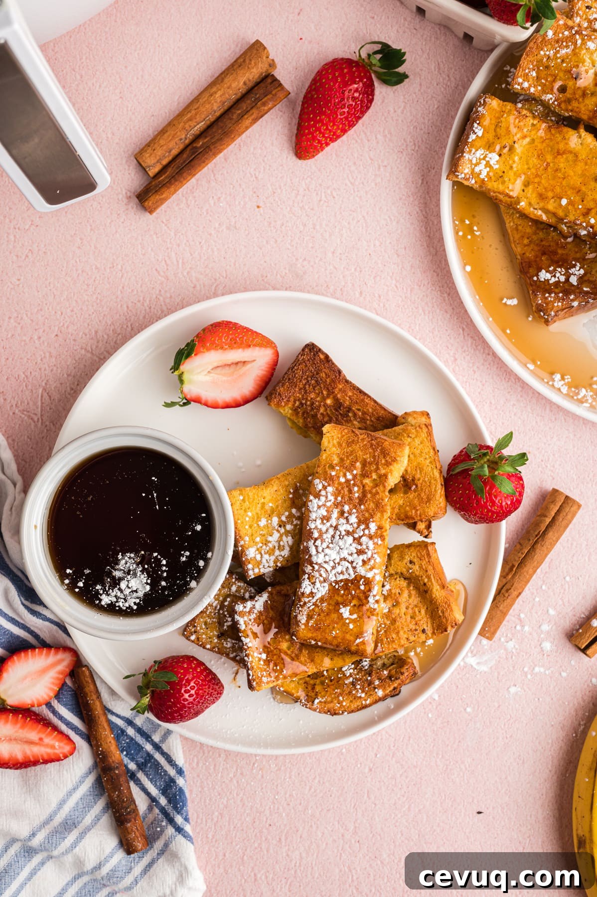 Overhead view of a plate of homemade French toast sticks with syrup