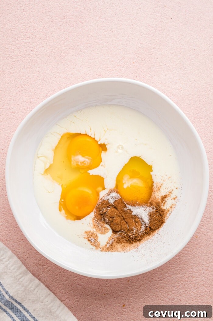 Milk, eggs, and cinnamon in a bowl