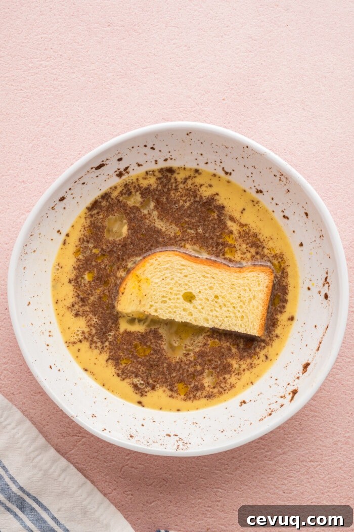 A 1/3 slice of bread dipped into French toast batter