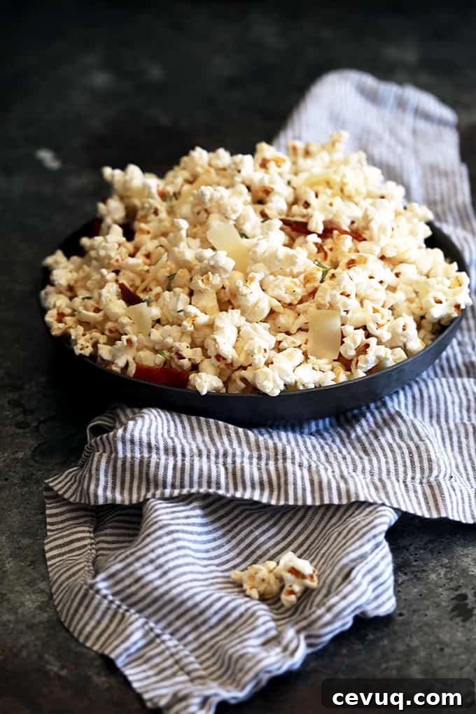 A generous bowl of Rosemary Parmesan Bacon Popcorn ready to serve.
