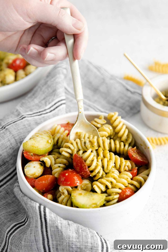 spoon digging into bowl of pasta salad