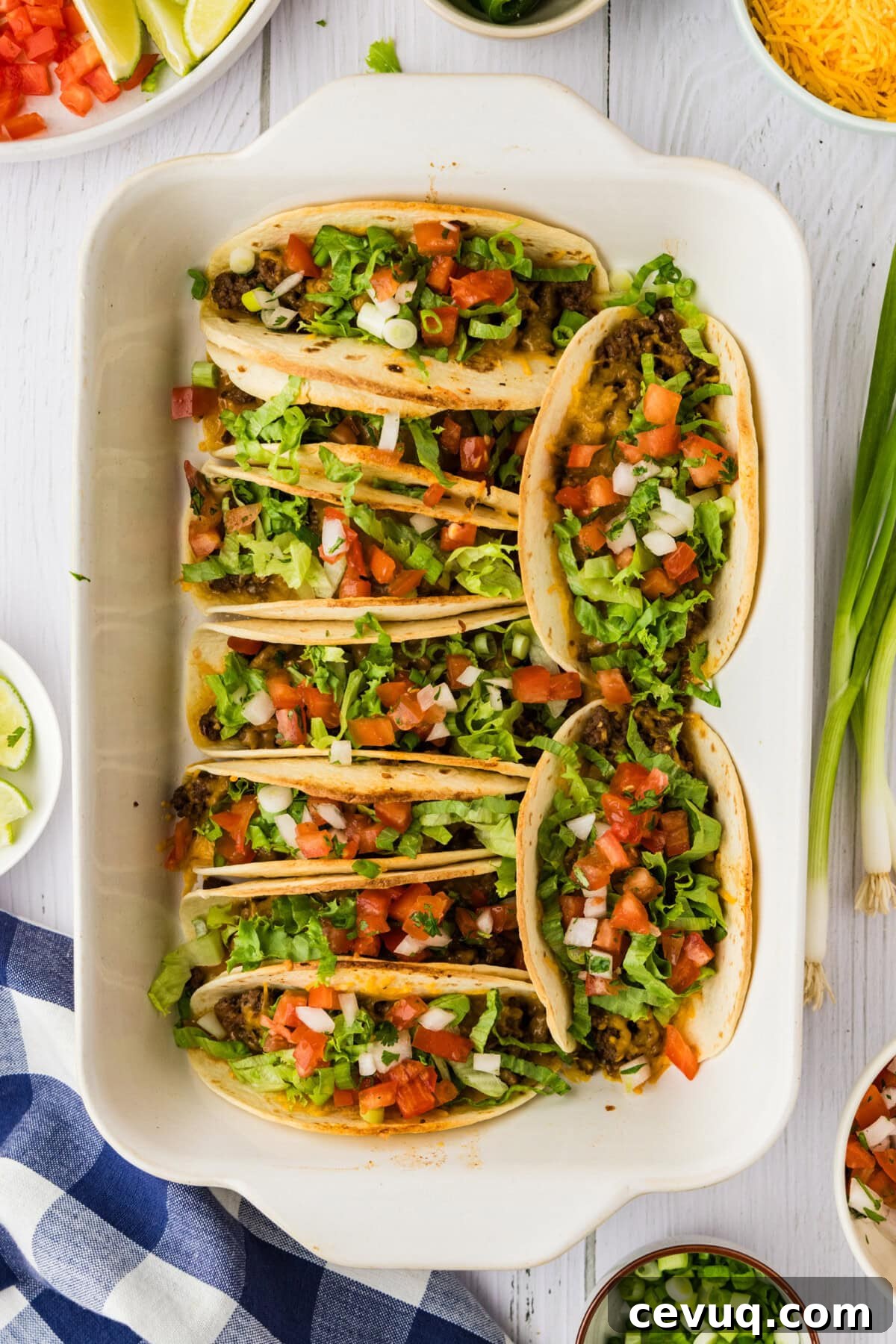 overhead photo of oven tacos with toppings in pan