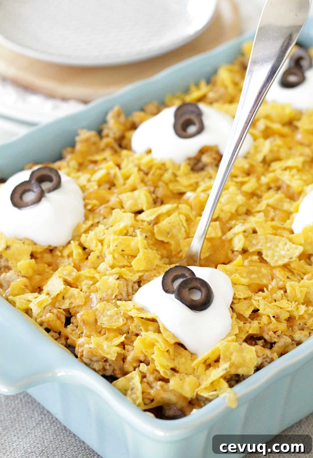 cheesy mexican rice casserole in dish with spoon