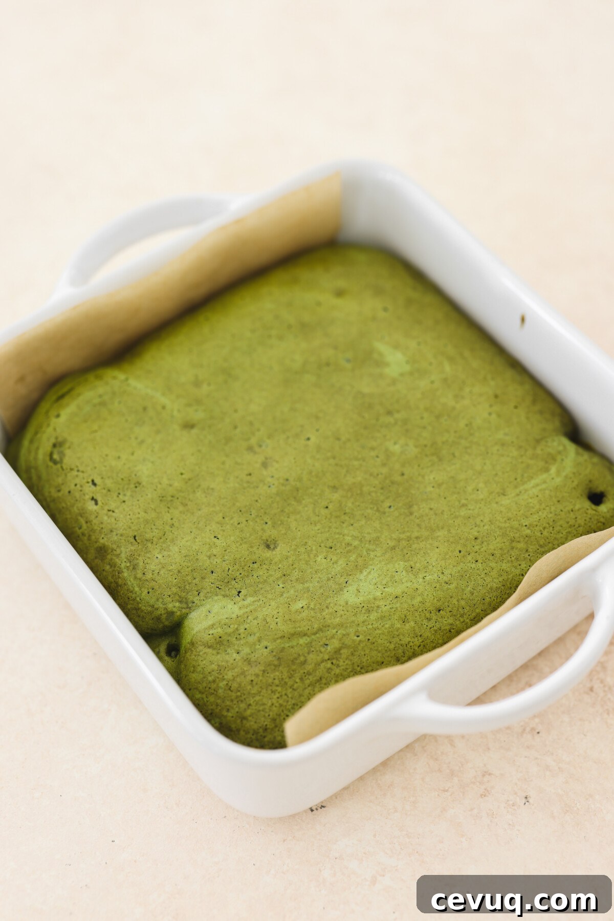 a matcha cake in a baking pan