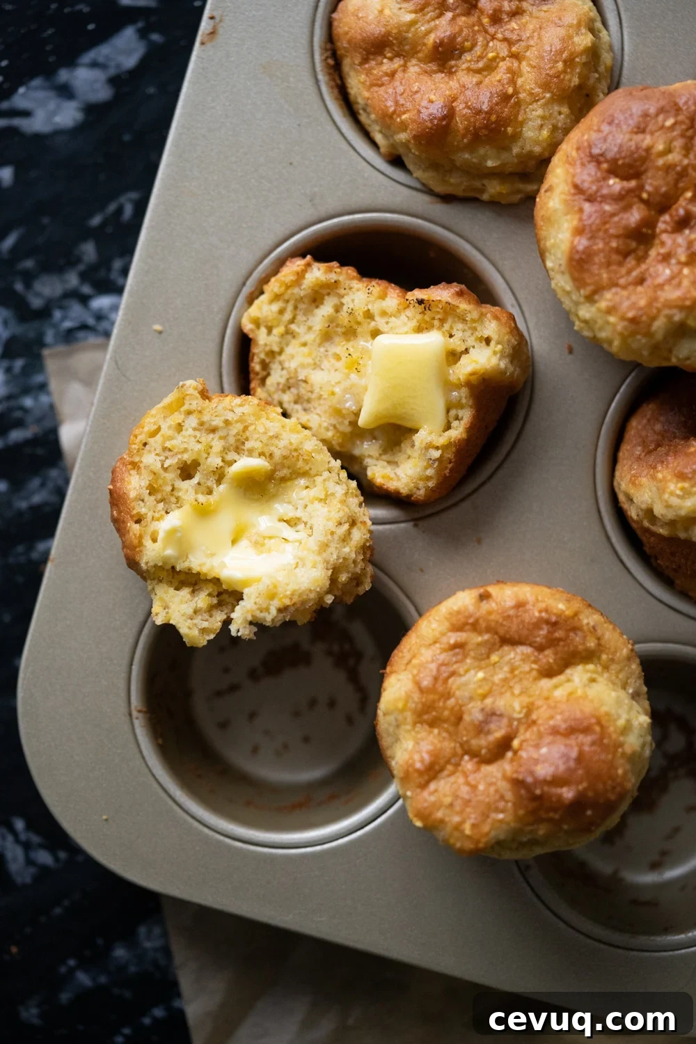 Freshly baked low carb cornbread with cornmeal and a pat of butter melting through