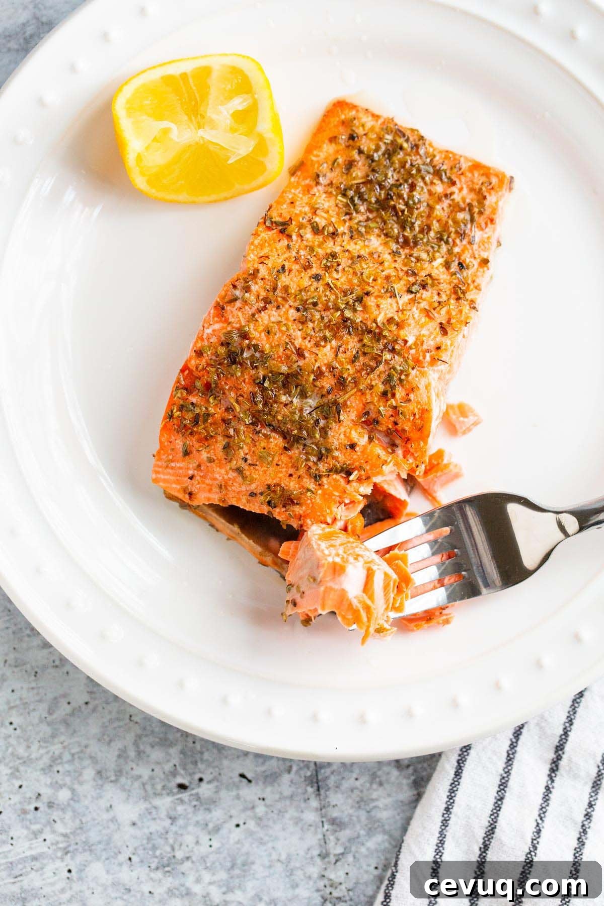Cooked salmon flaked on a plate.