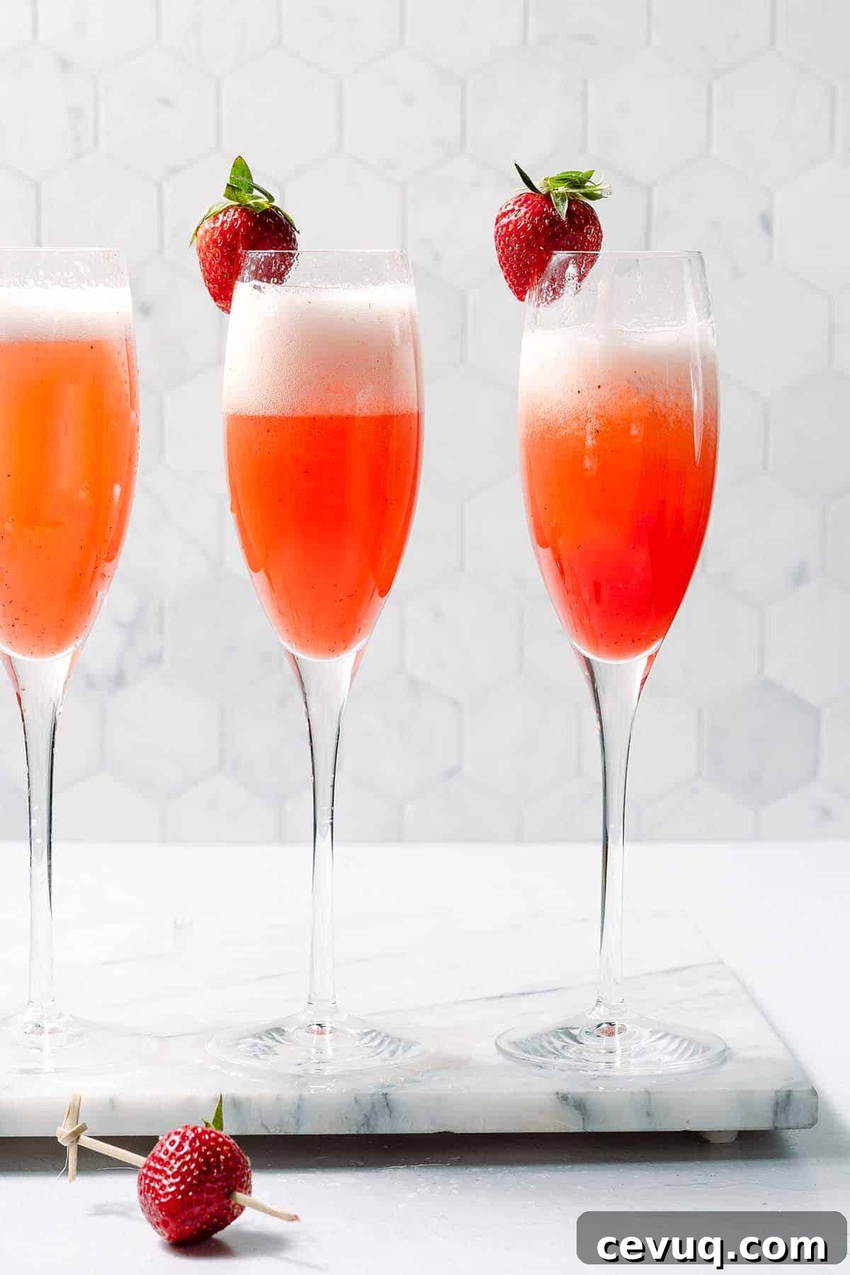 three glasses of strawberry mimosas
