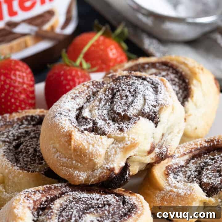 Nutella puff pastry swirls on a plate.