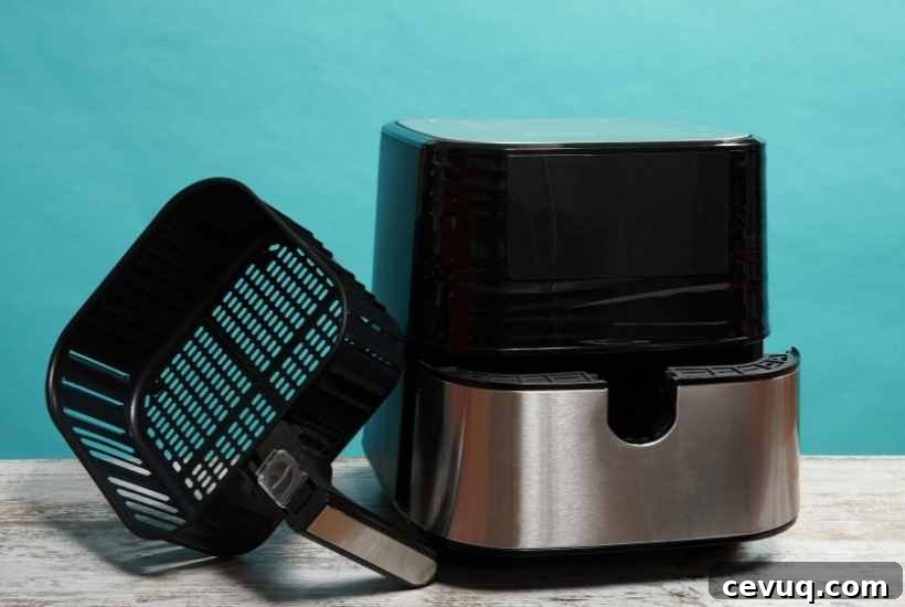 air fryer with basket sitting next to it