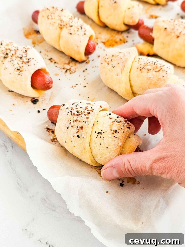 hot dogs wrapped in bread dough and sprinkled with everything bagel seasoning