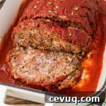 Close up view of a Cajun meatloaf sliced in a baking dish.