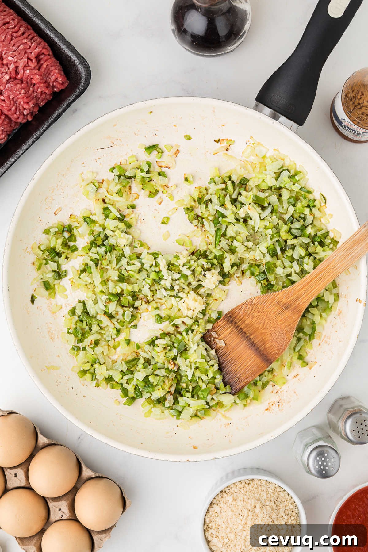 A large skillet cooking some veggies.