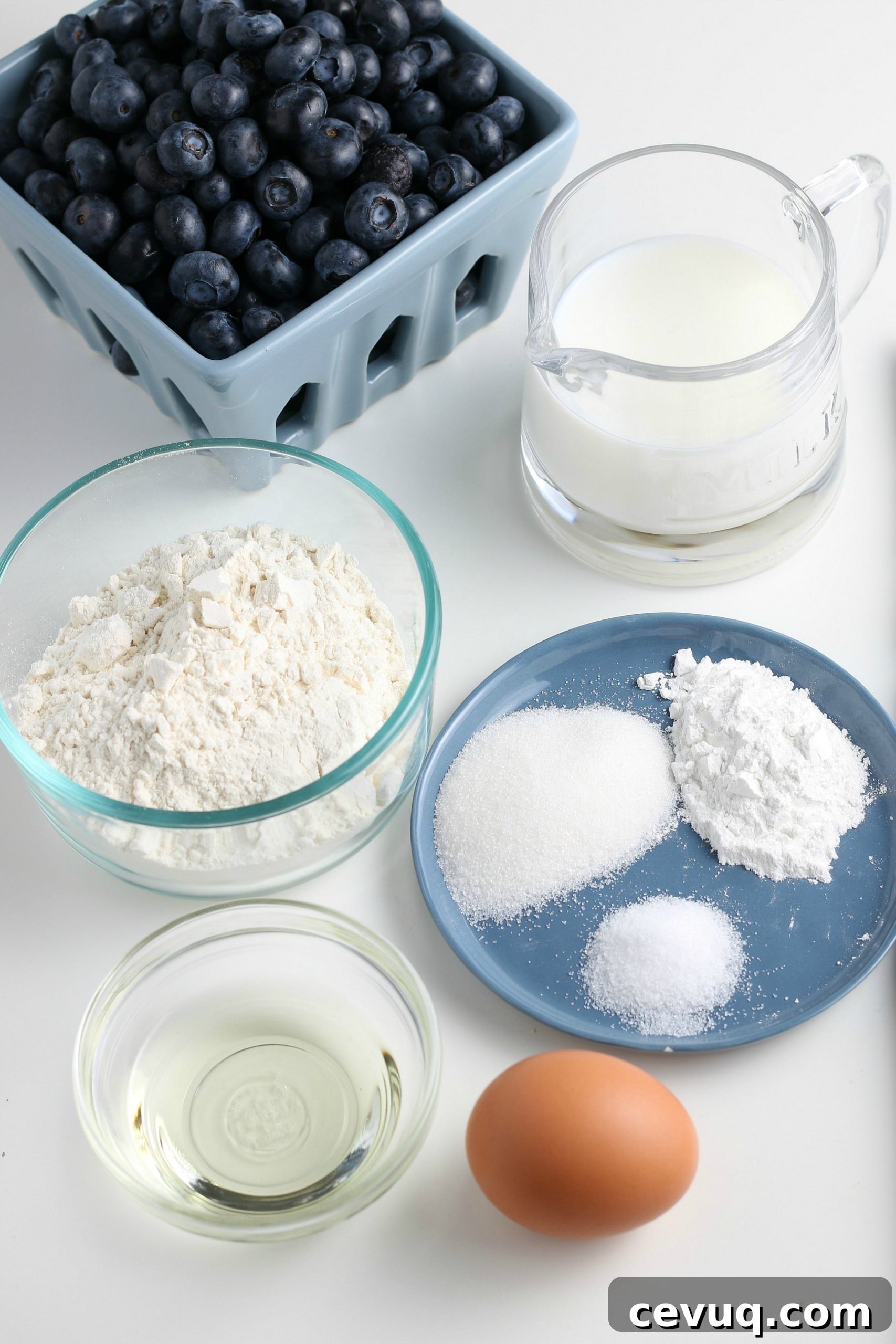 ingredients for homemade blueberry pancakes on a white countertop