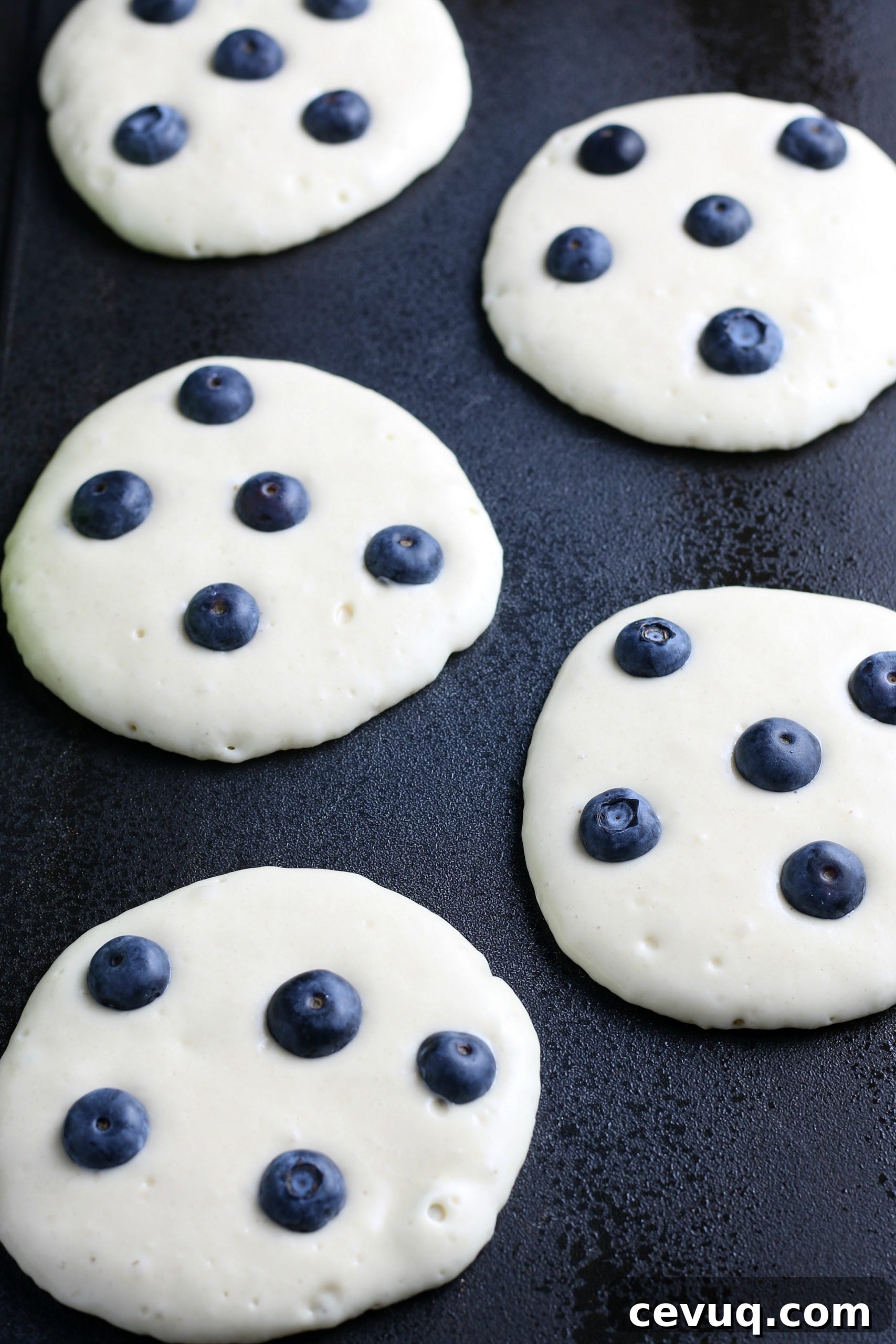 blueberry pancakes on a griddle